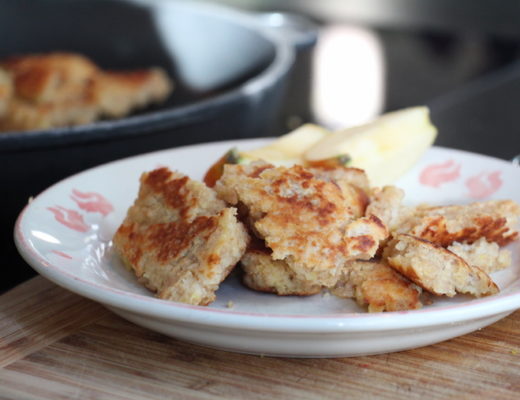 Kaiserschmarrn mit Cuscous auf einem Teller mit Apfelschnitzen.